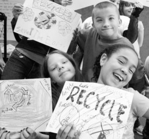 Smiling kids with recycling art