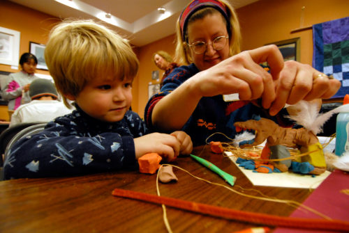 Boy and Mom work on clay sculpture