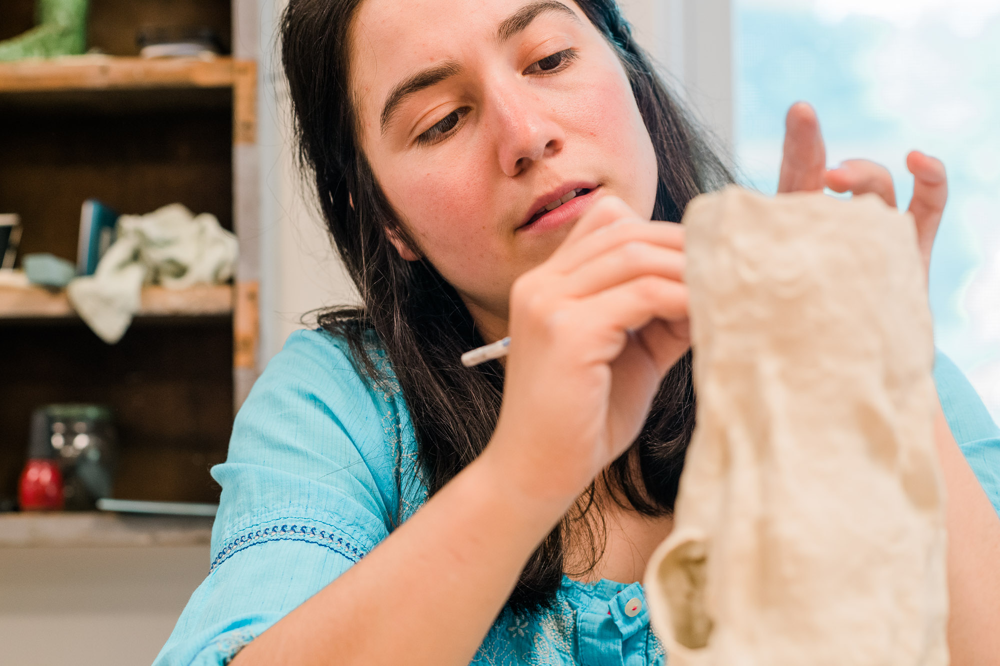Lily Fein demonstrates her hand rolled and sculpted porcelain techniques. 