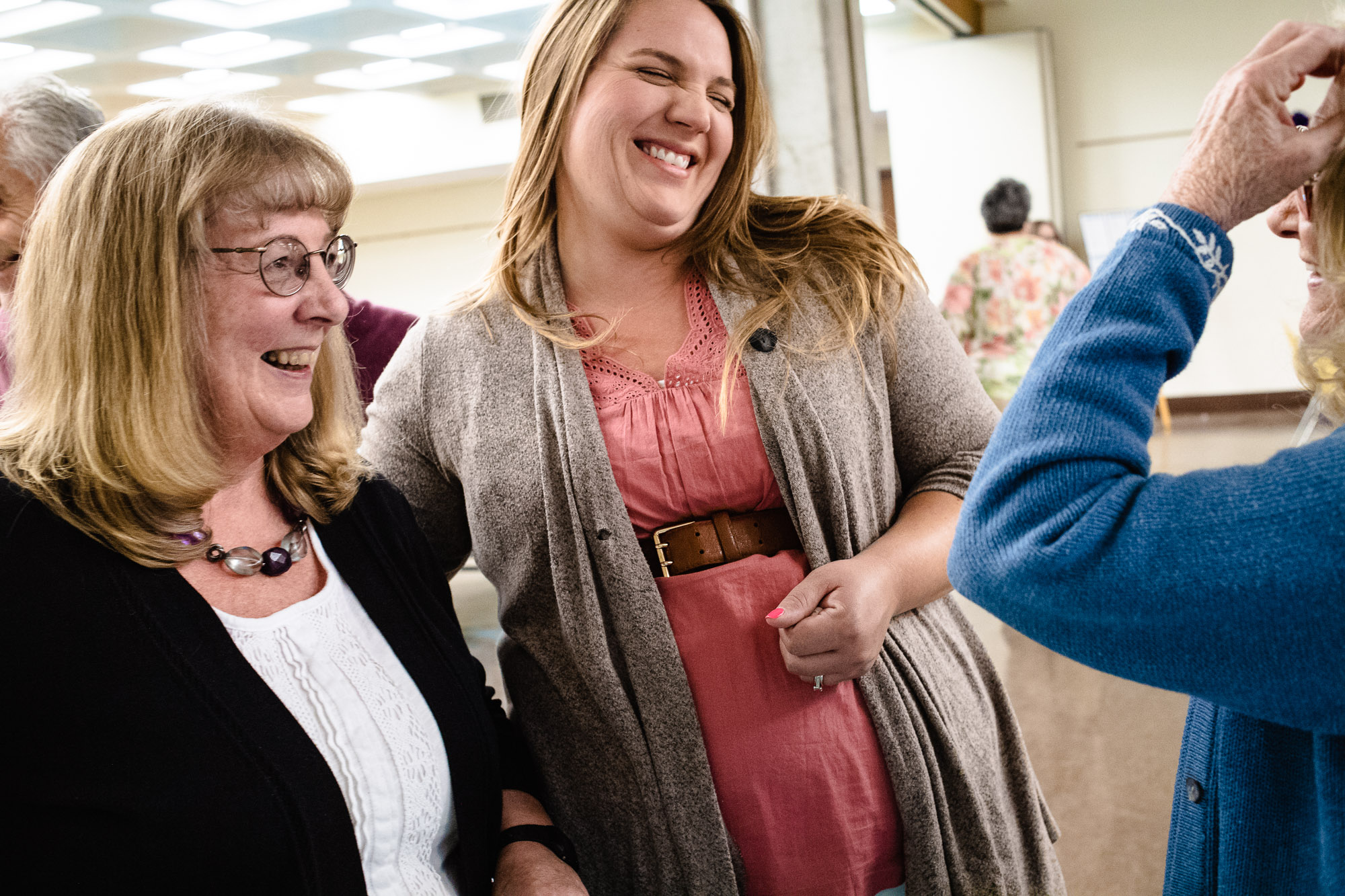 Kathy Reilly and her daughter Becca Campion laugh during a conversation at her retirement party from the Berkshire Athenaeum in Pittsfield, MA
