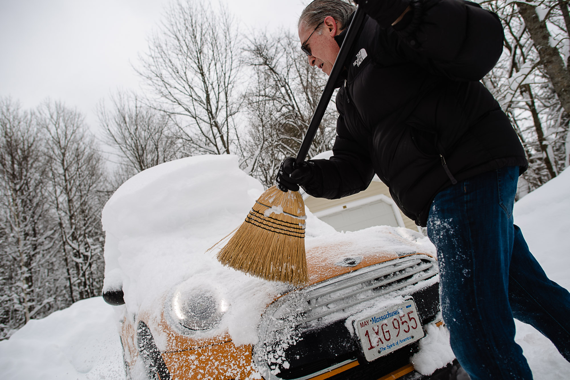 Don LeClaire frees his mini Cooper after a 14 inch snowstorm.
